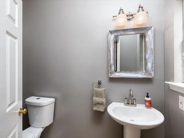 an aerial view of a house with a yard and street