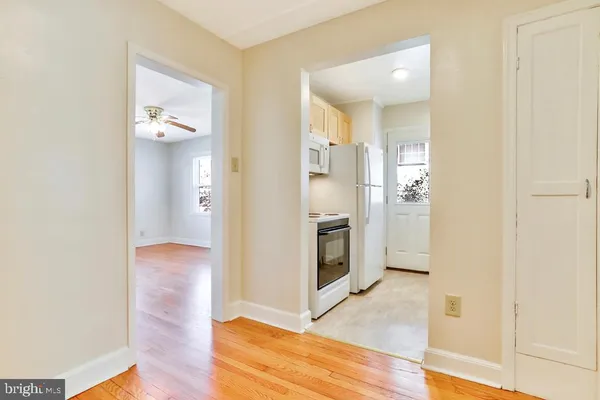 a view of kitchen and utility room with wooden floor