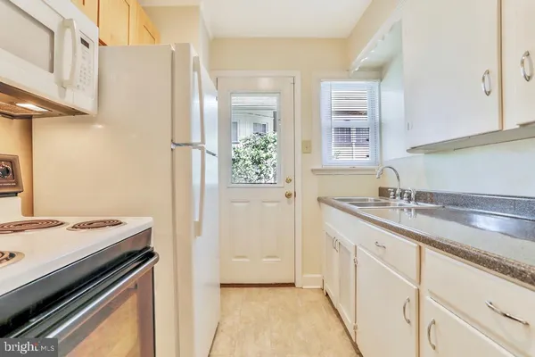 a kitchen with a sink stove and refrigerator