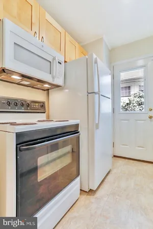 a stove top oven sitting inside of a kitchen