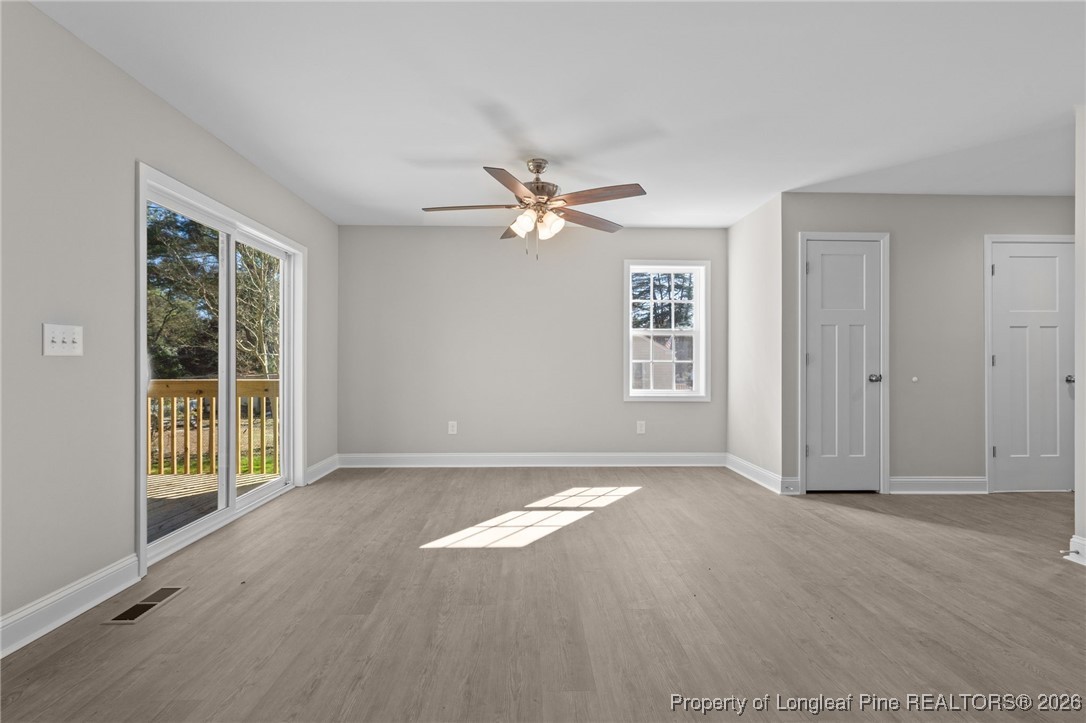 1010 Saunders Avenue Aberdeen, NC 28315 - Photo 14 of 44 an empty room with windows and ceiling fan