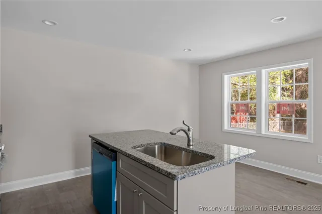 a kitchen that has a sink and cabinets