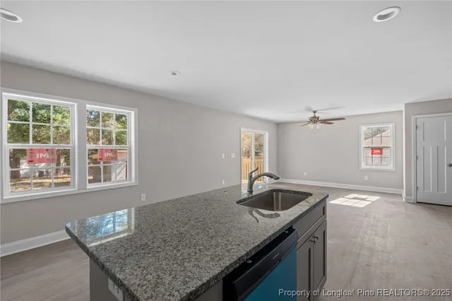 a kitchen with granite countertop a sink and a window