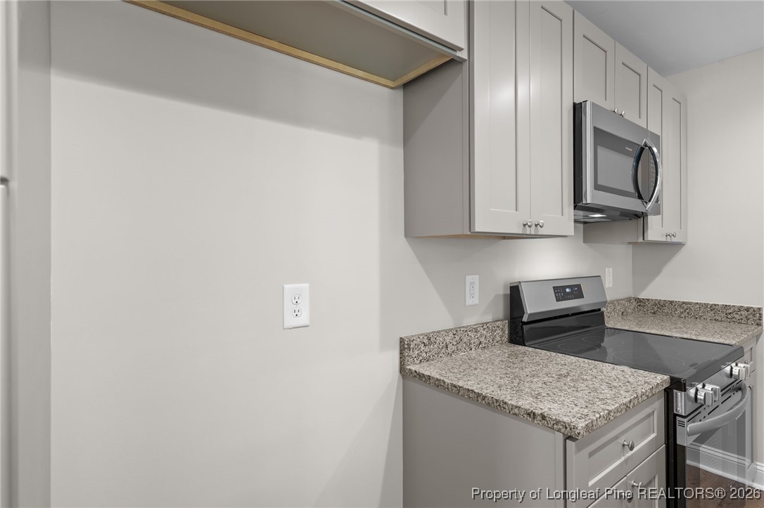 1010 Saunders Avenue Aberdeen, NC 28315 - Photo 21 of 44 a kitchen with stainless steel appliances granite countertop a sink and a microwave