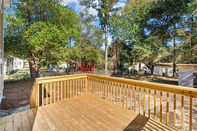 a view of balcony with wooden floor and fence