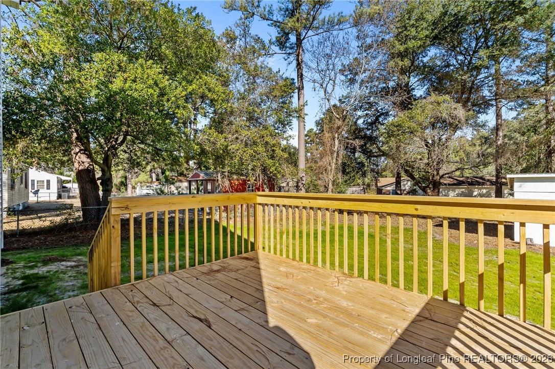 1010 Saunders Avenue Aberdeen, NC 28315 - Photo 39 of 44 a balcony with wooden floor and trees