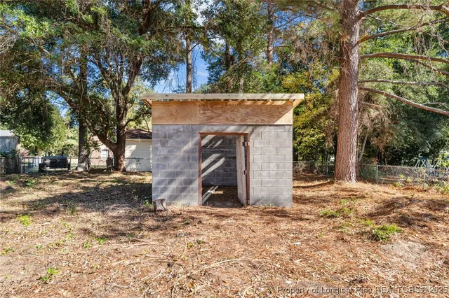 a view of a tiny house with a tree in the background