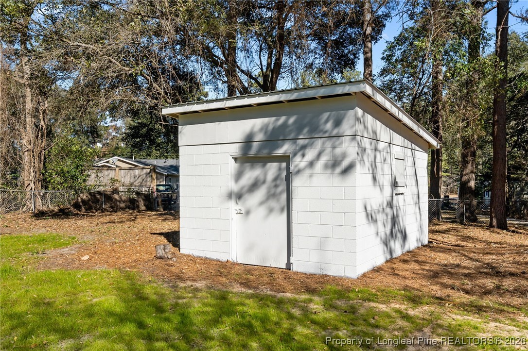1010 Saunders Avenue Aberdeen, NC 28315 - Photo 40 of 44 a view of wooden house with a large trees