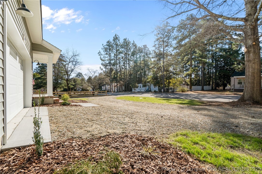 1010 Saunders Avenue Aberdeen, NC 28315 - Photo 4 of 44 a view of a swimming pool with an outdoor space and seating area