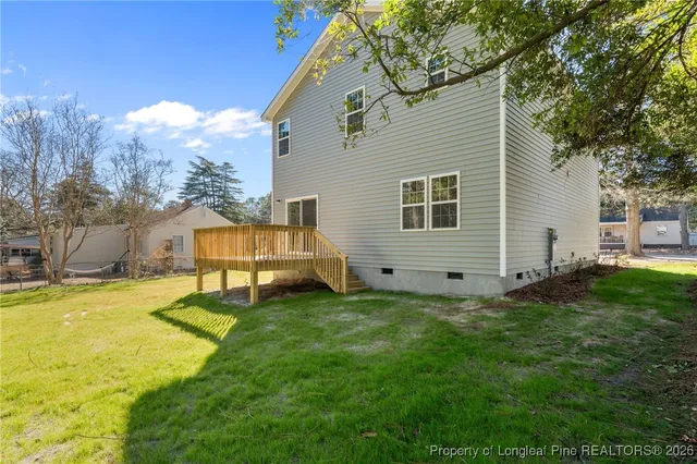 a backyard of a house with table and chairs