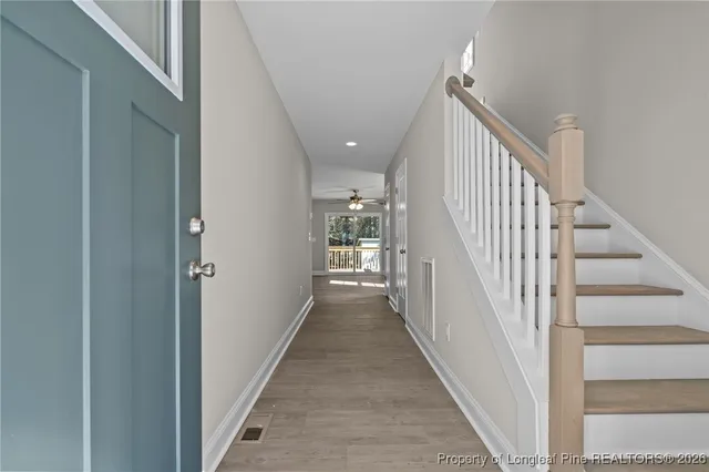 a view of a hallway view with staircase