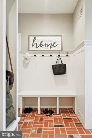 a large kitchen with stainless steel appliances kitchen island granite countertop a large center island and a refrigerator