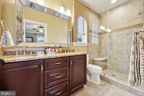 a spacious bedroom with a bed and a flat screen tv