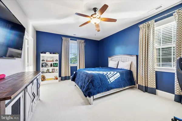 a bedroom with a bed and a couch