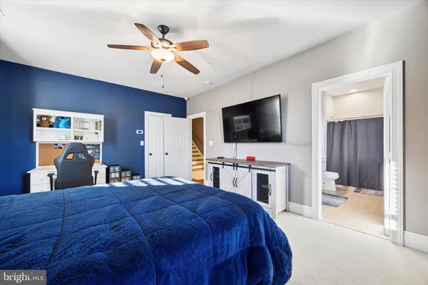 a bathroom with a granite countertop sink a toilet and a mirror