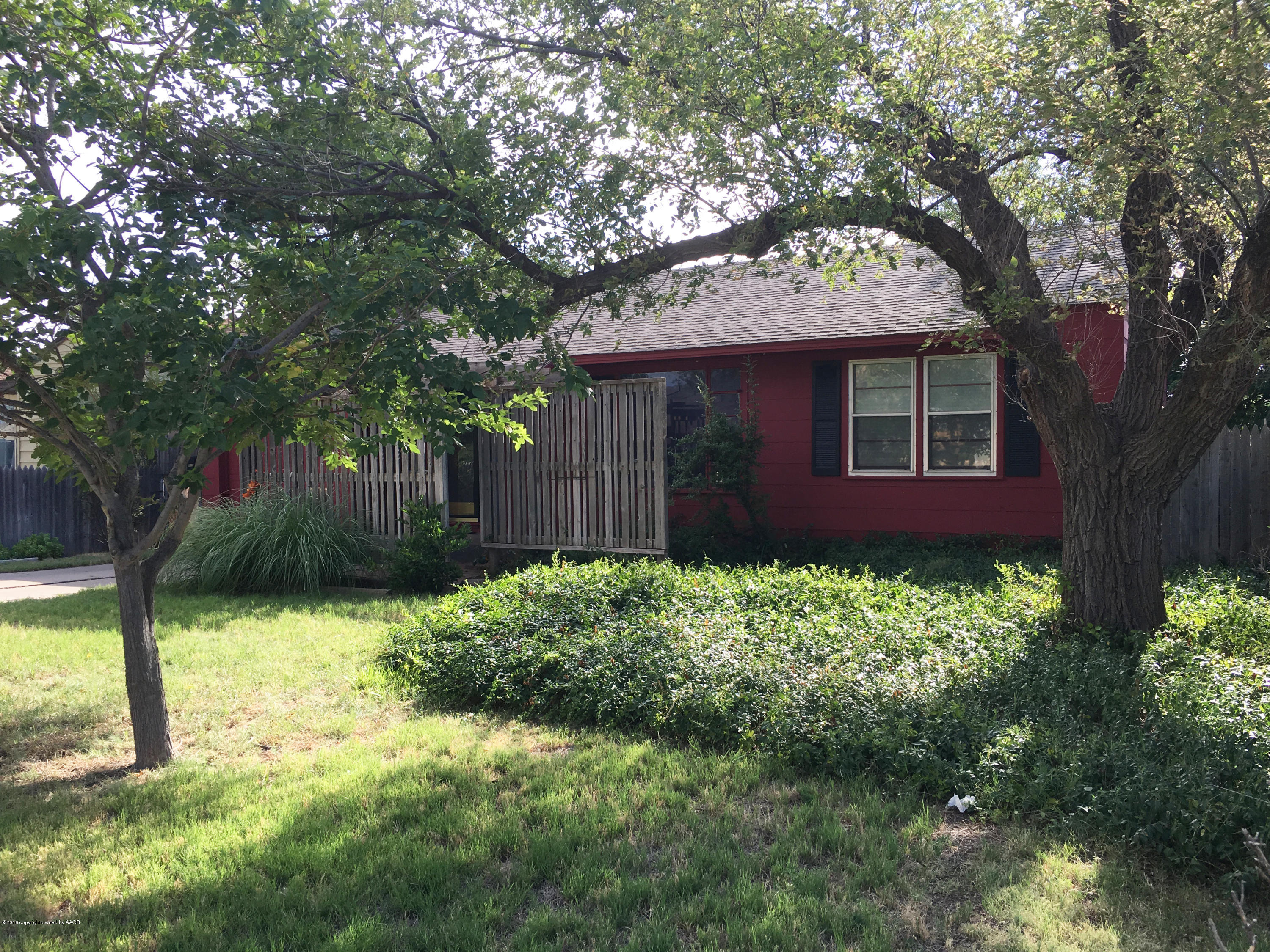 4619 South Lipscomb Street Amarillo, TX 79110 - Photo 1 of 15 a brick house with a large tree in front of it