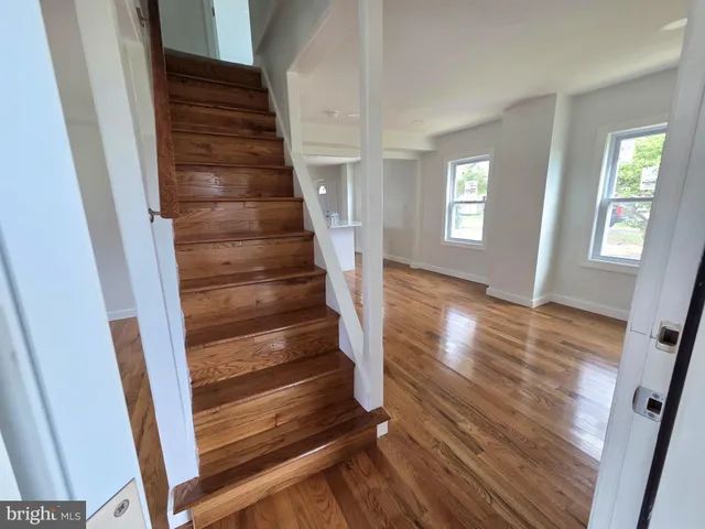 a view of entryway with wooden floor and stairs