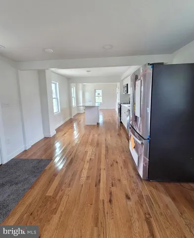 a view of a living room with wooden floor