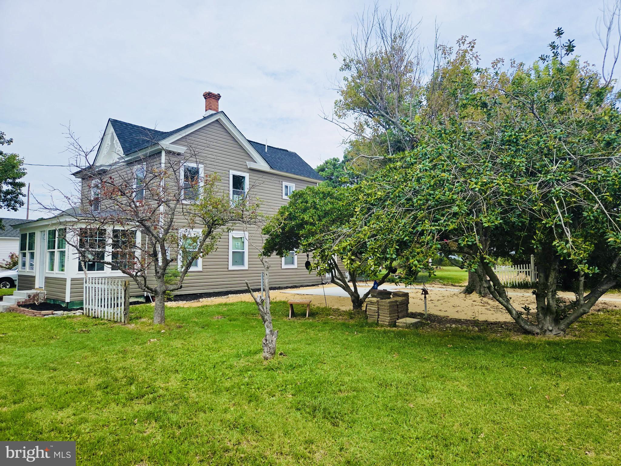 2527 Old House Point Road Fishing Creek, MD 21634 - Photo 2 of 34 a front view of a house with a yard