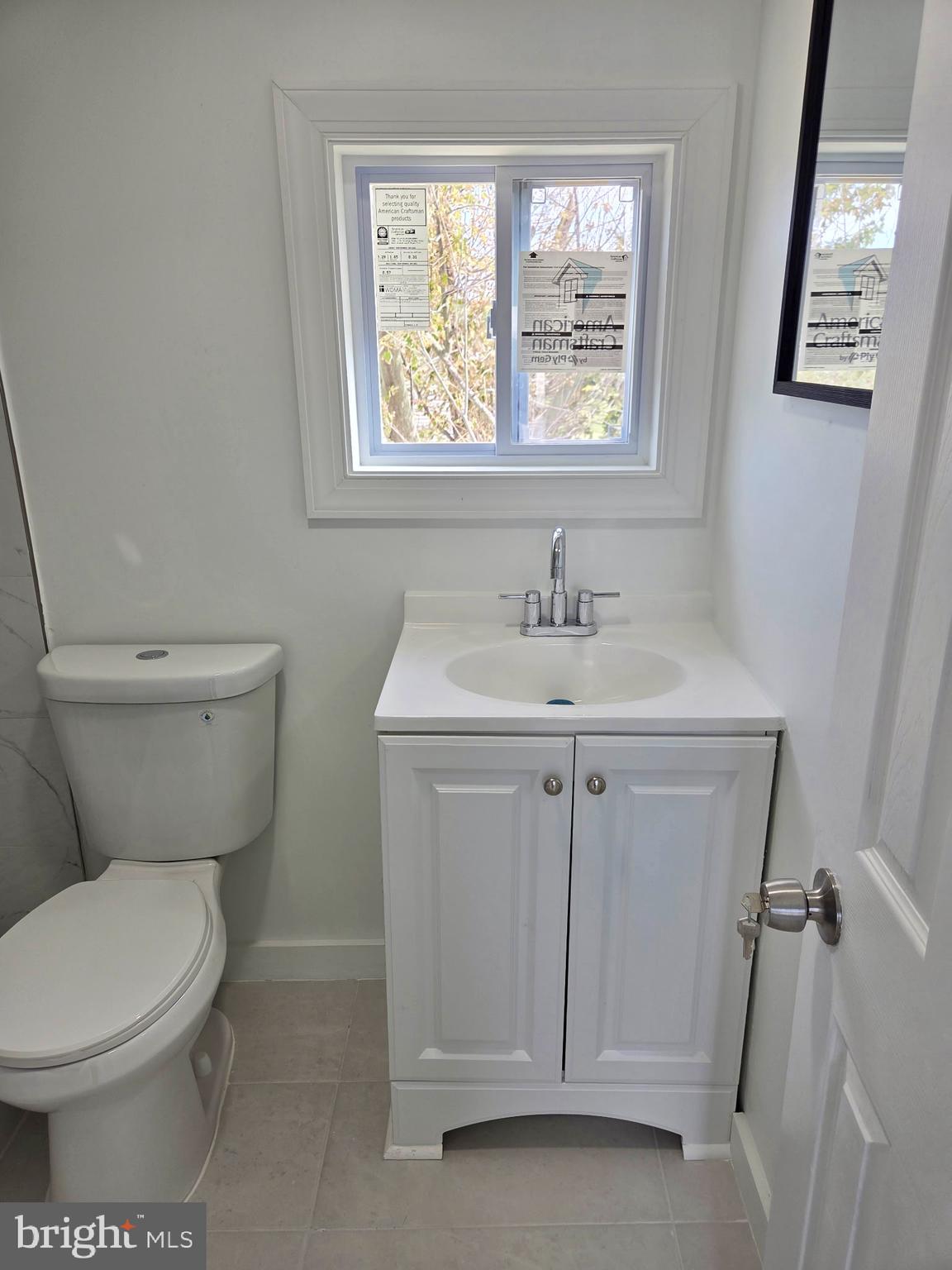 2527 Old House Point Road Fishing Creek, MD 21634 - Photo 22 of 34 a bathroom with a toilet sink and window