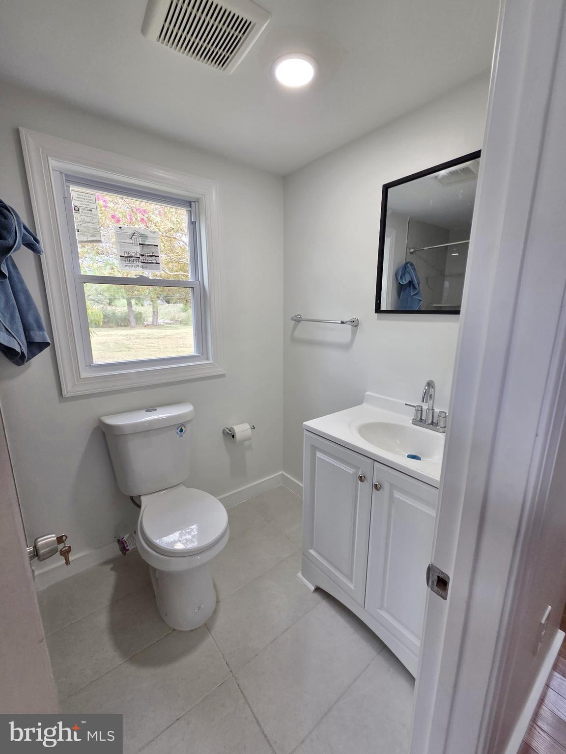 2527 Old House Point Road Fishing Creek, MD 21634 - Photo 27 of 34 a bathroom with a toilet sink and mirror