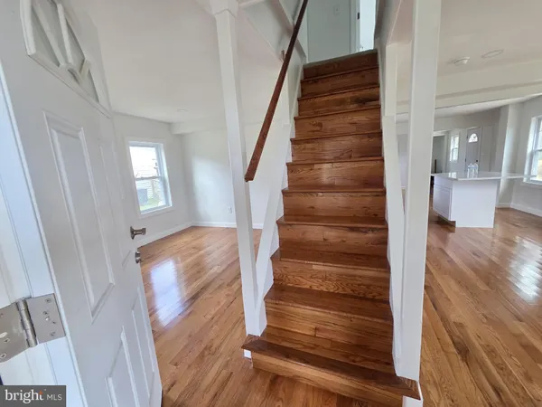 a view of entryway and gallery with wooden floor