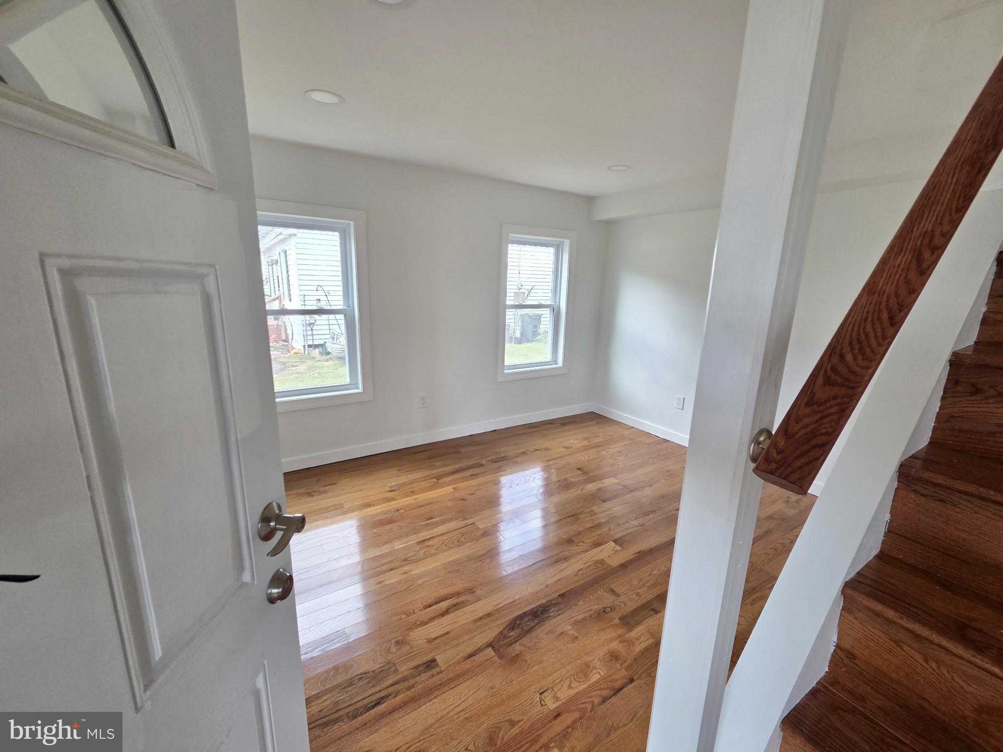 2527 Old House Point Road Fishing Creek, MD 21634 - Photo 9 of 34 a view of an empty room with wooden floor and stairs