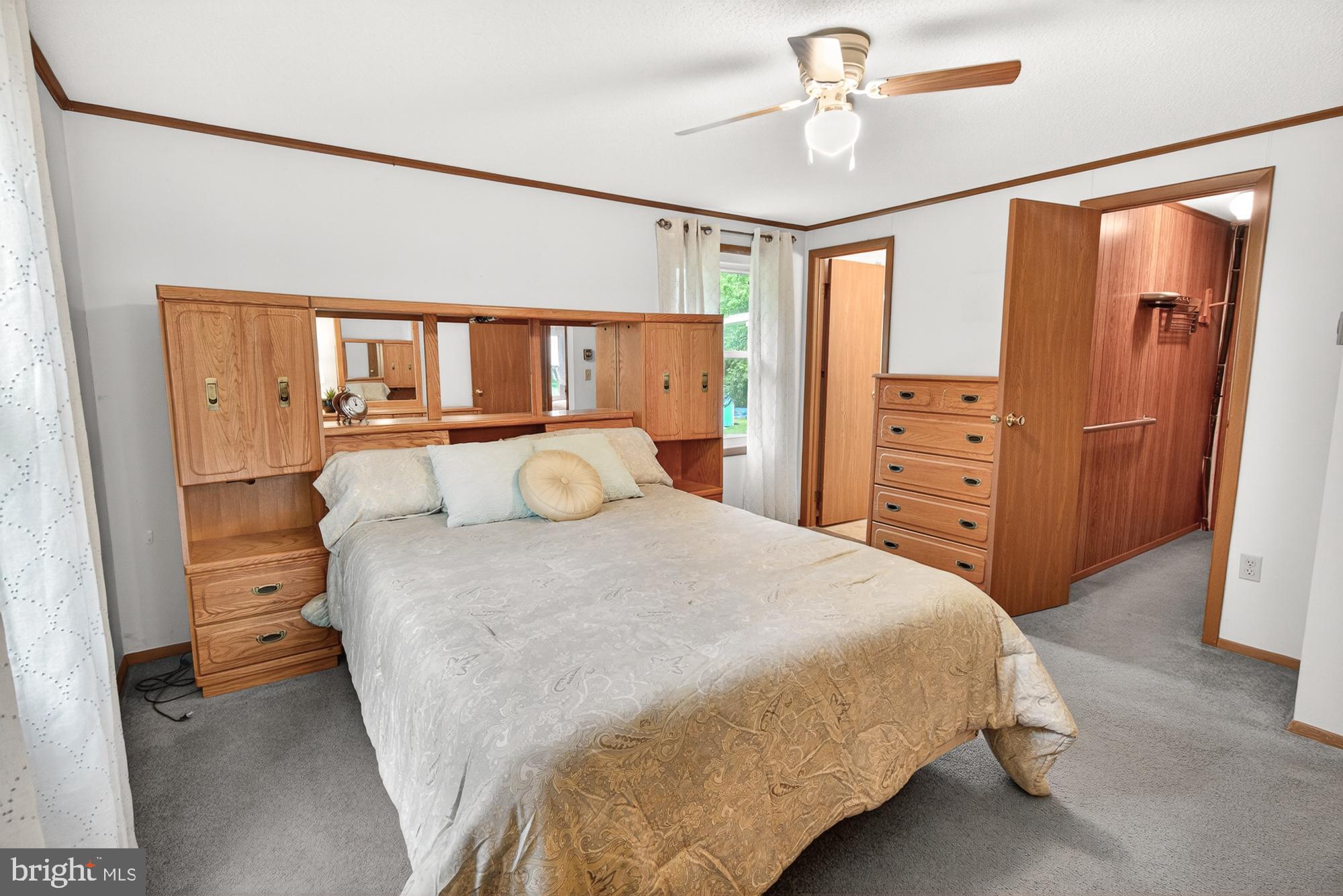5601 Woodville Road Mount Airy, MD 21771 - Photo 23 of 54 a bedroom with a bed dresser and a window