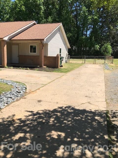 6718 Idlewild Road Charlotte, NC 28212 - Photo 2 of 12 a view of house with backyard and trees