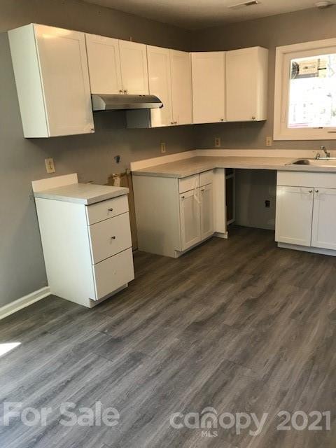 6718 Idlewild Road Charlotte, NC 28212 - Photo 5 of 12 a kitchen with appliances cabinets and a sink