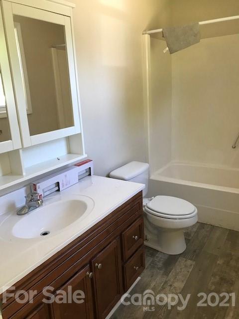 6718 Idlewild Road Charlotte, NC 28212 - Photo 6 of 12 a bathroom with a sink a toilet and shower