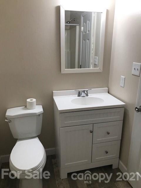 6718 Idlewild Road Charlotte, NC 28212 - Photo 7 of 12 a bathroom with a toilet sink and mirror