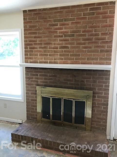 6718 Idlewild Road Charlotte, NC 28212 - Photo 8 of 12 a living room with a fireplace