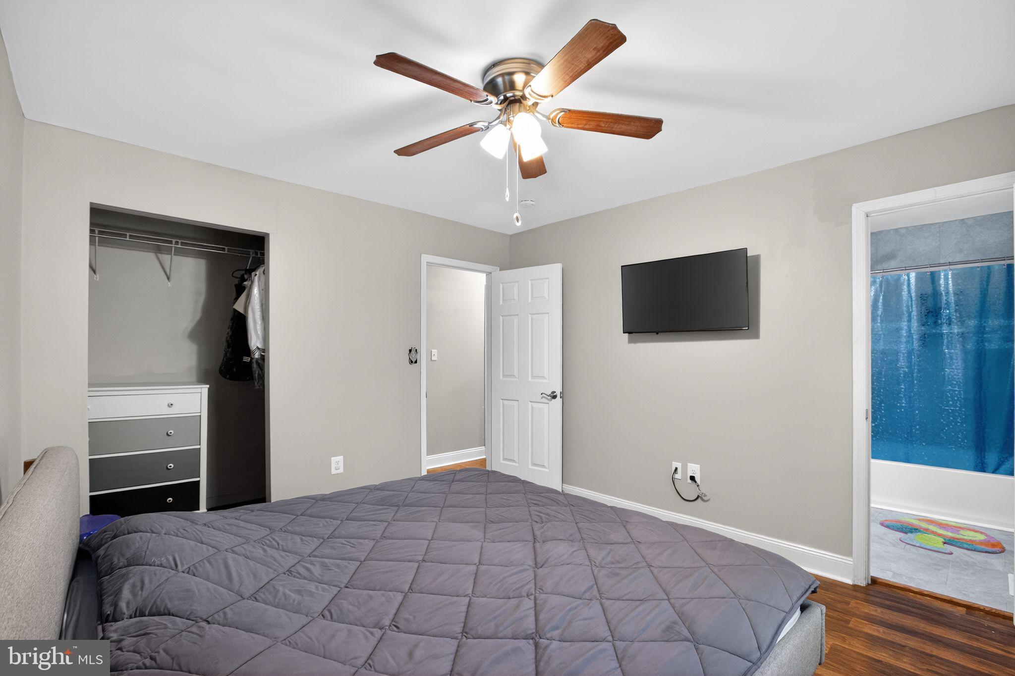 11789 Little Cove Point Road Lusby, MD 20657 - Photo 12 of 16 a bedroom with a bed and a flat tv screen on dresser