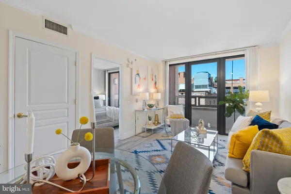 a living room filled with furniture and a window