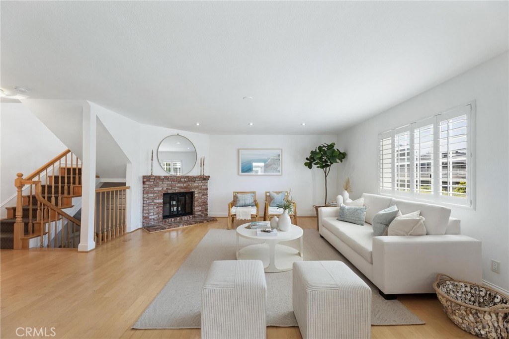 1421 12th Street, Unit 1 Manhattan Beach, CA 90266 - Photo 1 of 36 a living room with furniture a fireplace and a floor to ceiling window