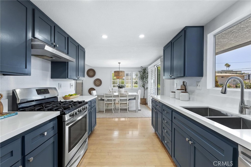 1421 12th Street, Unit 1 Manhattan Beach, CA 90266 - Photo 11 of 36 a kitchen with stainless steel appliances granite countertop a sink stove and cabinets