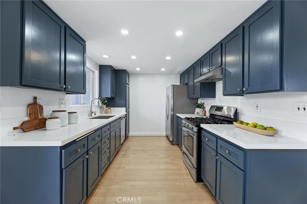 1421 12th Street, Unit 1 Manhattan Beach, CA 90266 - Photo 14 of 36 a kitchen with kitchen island granite countertop stainless steel appliances lots of counter space sink and cabinets