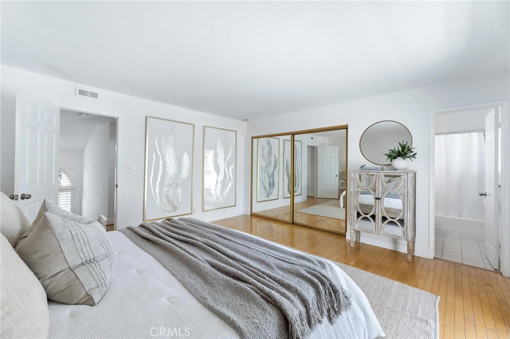 1421 12th Street, Unit 1 Manhattan Beach, CA 90266 - Photo 20 of 36 a bedroom with a bed a mirror and a large window