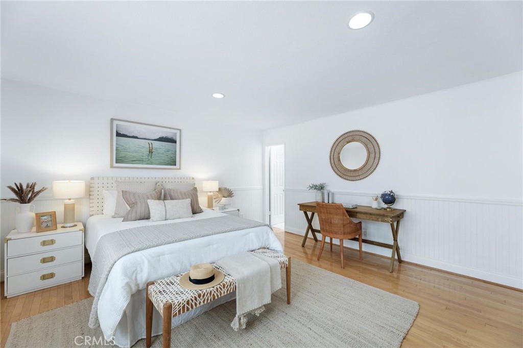 1421 12th Street, Unit 1 Manhattan Beach, CA 90266 - Photo 25 of 36 a bedroom with a bed and wooden floor