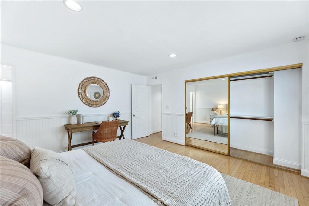 1421 12th Street, Unit 1 Manhattan Beach, CA 90266 - Photo 26 of 36 a bedroom with a bed and wooden floor