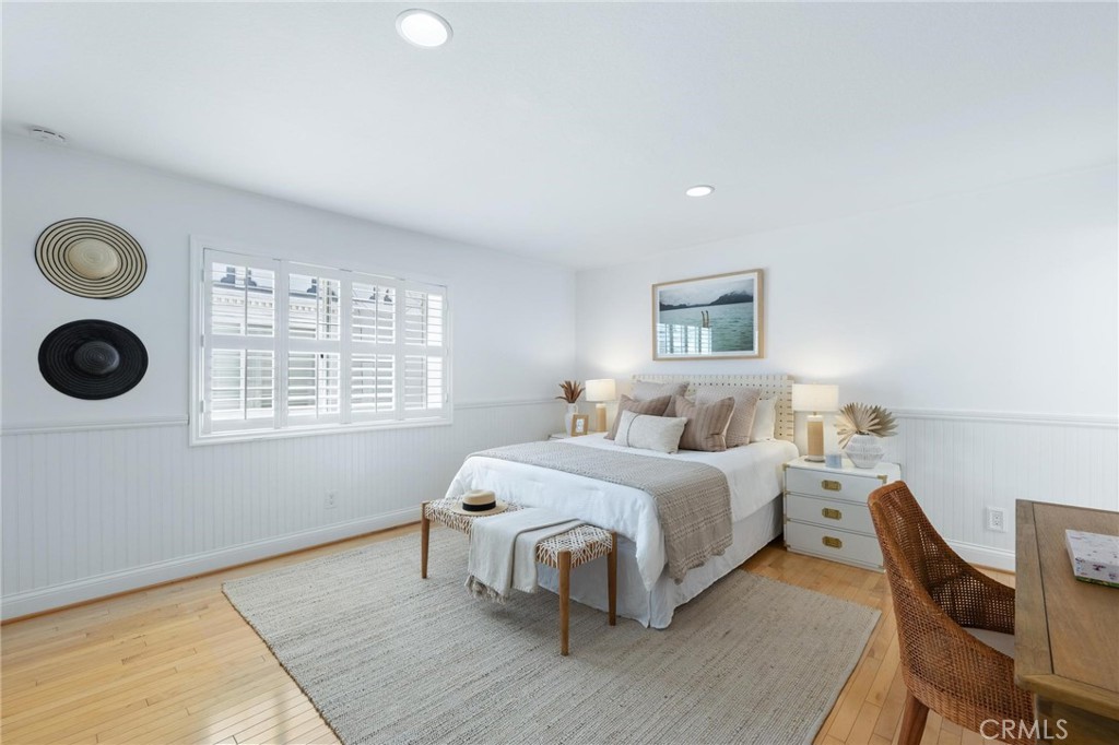 1421 12th Street, Unit 1 Manhattan Beach, CA 90266 - Photo 27 of 36 a spacious bedroom with a bed and cabinets