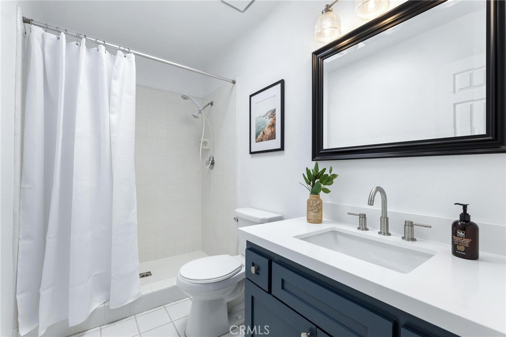 1421 12th Street, Unit 1 Manhattan Beach, CA 90266 - Photo 28 of 36 a bathroom with a sink a toilet and mirror