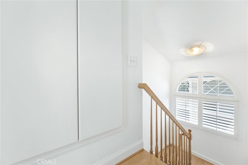 1421 12th Street, Unit 1 Manhattan Beach, CA 90266 - Photo 29 of 36 a view of staircase with railing and white walls