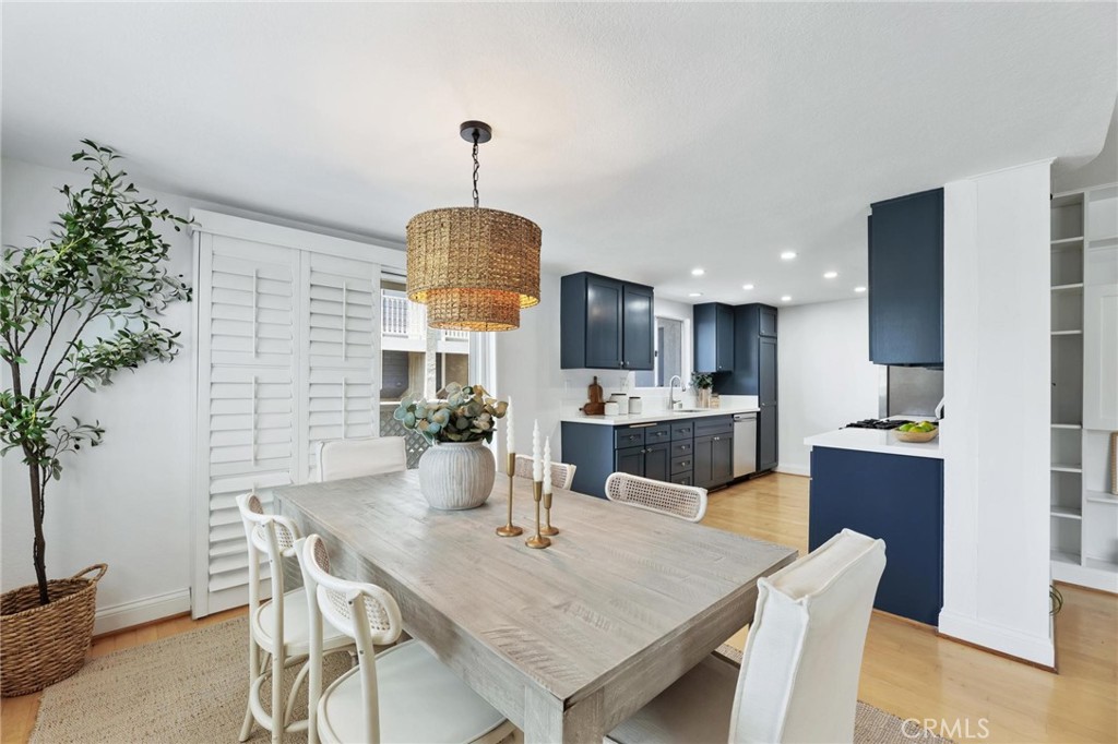 1421 12th Street, Unit 1 Manhattan Beach, CA 90266 - Photo 9 of 36 a kitchen with a table chairs refrigerator and microwave