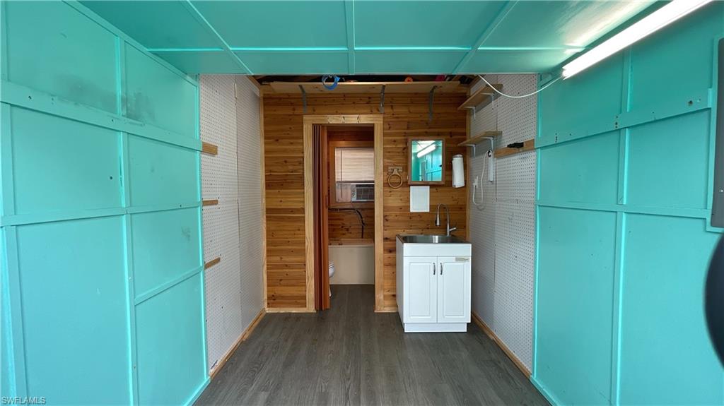 5184 Cypress Trail Resort Circle Fort Myers, FL 33905 - Photo 3 of 5 Corridor featuring wood walls and dark wood-type flooring