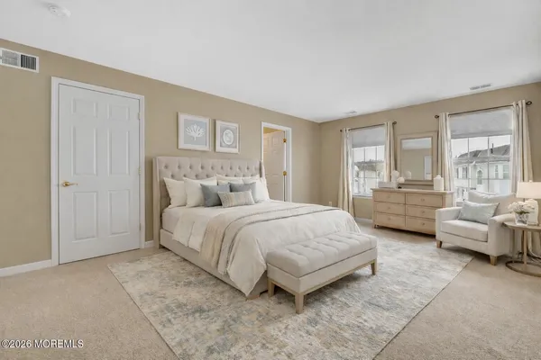 a bedroom with bed and large window