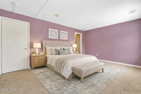 a bedroom with a bed and a potted plant