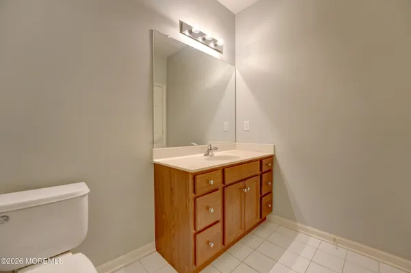 a bathroom with a sink toilet and mirror