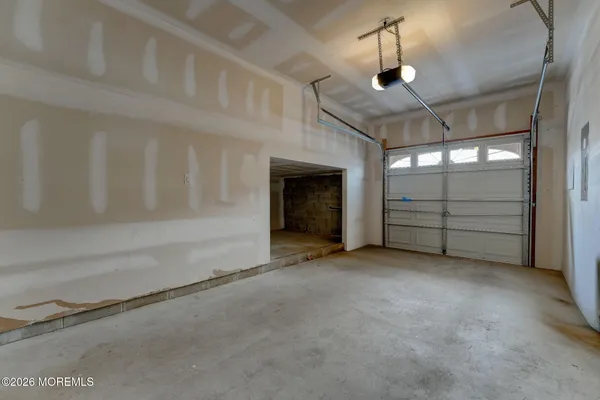 a view of a livingroom with an empty space and kitchen space